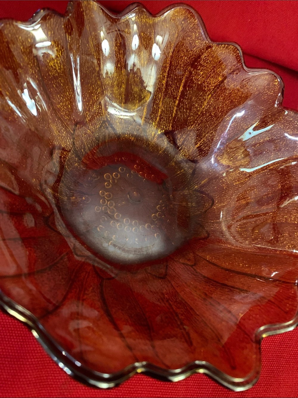 Vintage Carnival Glass amber iridescent bowl in a sunflower pattern.